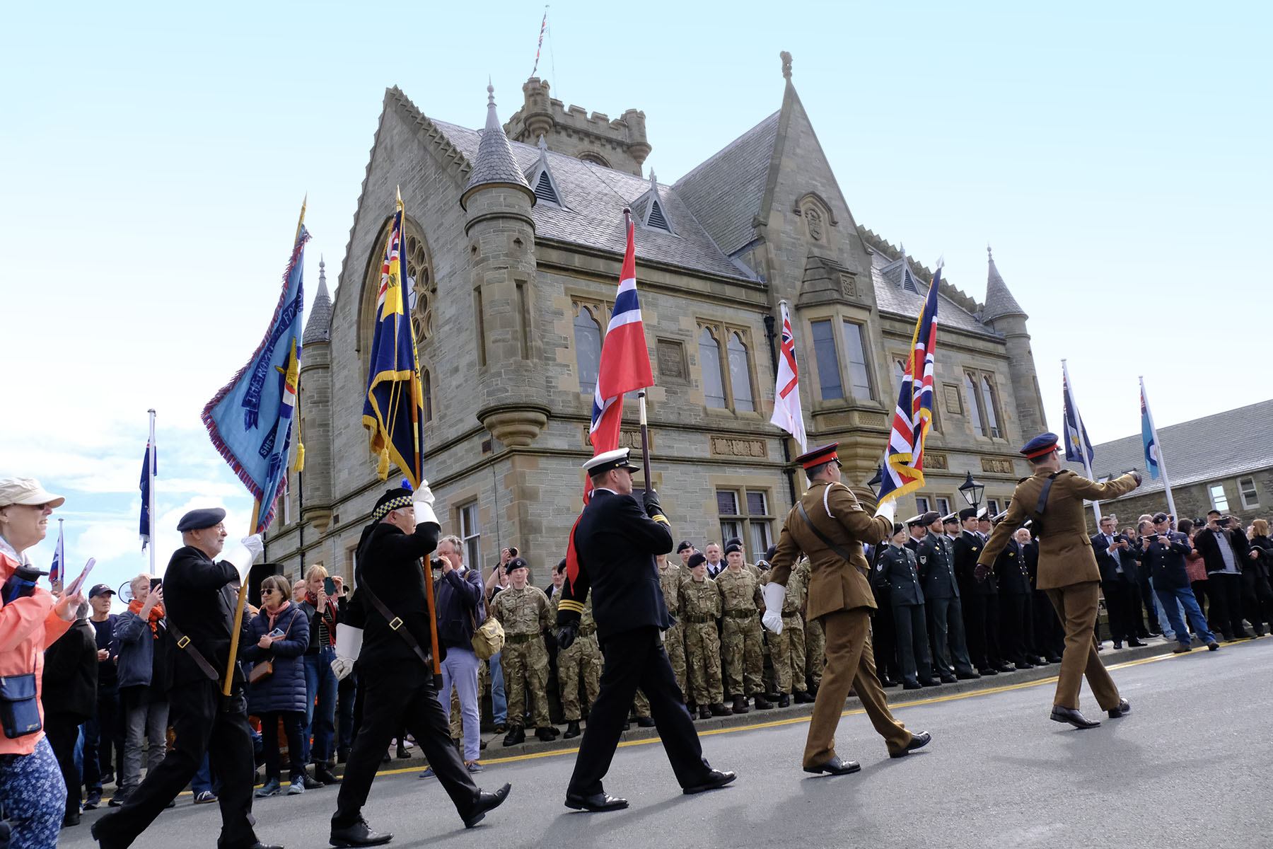 Crew members from the Liberation Convoy parade from Lerwick Harbour to Town Hall for a Civic Reception